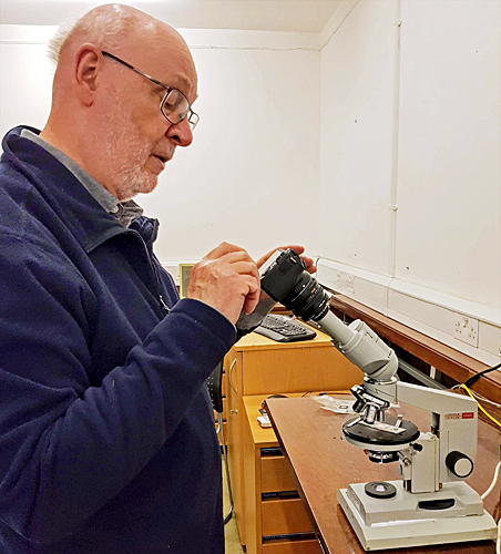 David Linstead with a Lomo polarising microscope