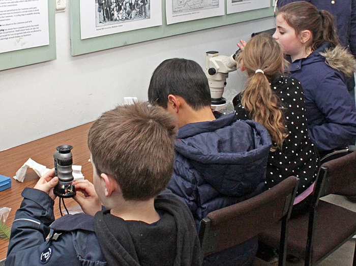 Four children with microscopes