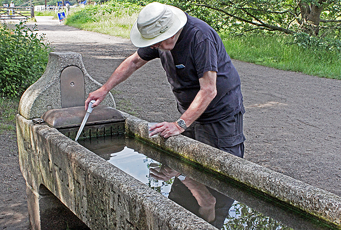 Paul Smith collecting from cattle trough