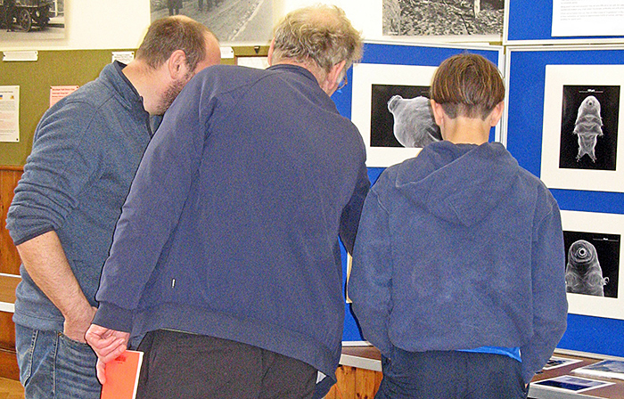 Visitors admiring Jeremy Poole’s photos of tardigrades