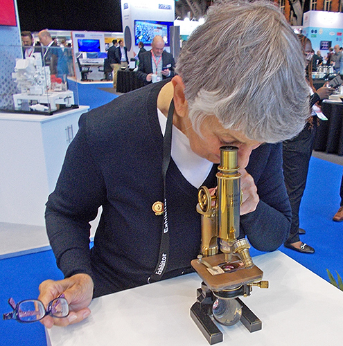 Pam Hamer with an old Zeiss microscope